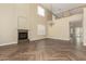 Living room with a fireplace, wood-look tile, and high ceilings at 15835 W Desert Mirage Dr, Surprise, AZ 85379