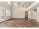 Large open living room with herringbone tile floor and backyard access at 15835 W Desert Mirage Dr, Surprise, AZ 85379