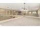 Spacious loft area with plush carpeting, decorative railing, and elegant lighting at 15835 W Desert Mirage Dr, Surprise, AZ 85379