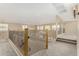 Upstairs hallway with carpeted floors and a decorative railing overlooking the living room at 15835 W Desert Mirage Dr, Surprise, AZ 85379