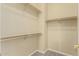 Spacious walk-in closet with built-in shelves and hanging rods at 15835 W Desert Mirage Dr, Surprise, AZ 85379