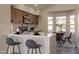 Modern kitchen with white countertops, stainless steel appliances, breakfast bar, and dining area at 16030 S 32Nd Pl, Phoenix, AZ 85048