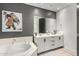 Bathroom boasts a soaking tub and double vanity at 17 W Vernon Ave # 103, Phoenix, AZ 85003