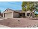 Exterior view of a single-story home with a two-car garage and landscaping at 17994 N Verde Roca Dr, Surprise, AZ 85374