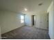 Spacious bedroom with plush carpeting and a large window offering plenty of natural light at 1937 E Parr Fame Ln, San Tan Valley, AZ 85140