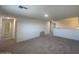 Carpeted loft area with an open railing and access to a bathroom at 1937 E Parr Fame Ln, San Tan Valley, AZ 85140