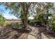 Landscaped backyard with a serene waterfall feature and stone path at 20171 N Bustos Way, Maricopa, AZ 85138