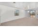 Spacious bedroom with plush carpeting and sliding glass door to balcony at 20171 N Bustos Way, Maricopa, AZ 85138