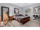 Cozy bedroom with rocking chair and built-in shelving at 20171 N Bustos Way, Maricopa, AZ 85138