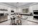 Modern kitchen with granite island, stainless steel appliances, and white cabinets at 20171 N Bustos Way, Maricopa, AZ 85138