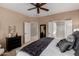 Spacious main bedroom with ensuite bathroom access and ceiling fan at 22006 N Arrellaga Dr, Sun City West, AZ 85375