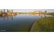 Serene community lake at sunset with walking paths and lush landscaping at 3202 N Lafayette Dr, Florence, AZ 85132