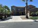 Two-story home with a three-car garage, palm trees, and a landscaped yard at 3333 E Powell Pl, Chandler, AZ 85249