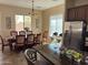 Open concept kitchen and dining area with wood cabinetry, stainless steel appliances, and tile floors at 3333 E Powell Pl, Chandler, AZ 85249