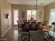 Kitchen and dining area with wood cabinetry, stainless steel appliances, and tile floors at 3333 E Powell Pl, Chandler, AZ 85249
