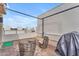 Private rooftop patio with wicker chairs, small table, and covered grill at 5151 N 13Th Pl # 16, Phoenix, AZ 85014