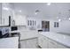 Modern kitchen with white cabinets, stainless steel appliances, and an island with quartz countertop at 7279 S Morning Dew Ln, Buckeye, AZ 85326