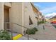 Side view of a condo building with stairs, desert landscaping, and a parking area at 7436 E Chaparral Rd # 159B, Scottsdale, AZ 85250