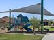 Community playground with slides, climbing structures, and shade sails, offering outdoor recreation for children at 8661 W Warner St, Tolleson, AZ 85353