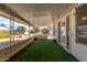 Covered back patio with artificial turf, offering relaxing outdoor space at 10330 W Desert Forest Cir, Sun City, AZ 85351