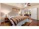 Bedroom with ceiling fan, wooden furniture, and hardwood flooring at 10330 W Desert Forest Cir, Sun City, AZ 85351