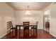 Dining room with chandelier, wood table, and wood flooring at 10330 W Desert Forest Cir, Sun City, AZ 85351