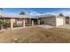 Single-story home exterior with attached garage, covered patio, and decorative metal fencing at 10330 W Desert Forest Cir, Sun City, AZ 85351
