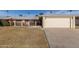 Front yard of a single-story home with attached garage, driveway, and landscaping at 10330 W Desert Forest Cir, Sun City, AZ 85351
