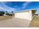 One-story home with an attached garage, a driveway, front lawn, and palm trees at 10330 W Desert Forest Cir, Sun City, AZ 85351