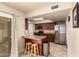 Kitchen with breakfast bar, granite countertops, stainless steel appliances, and wood cabinetry at 10330 W Desert Forest Cir, Sun City, AZ 85351
