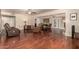 Spacious living room with wood floors, two ceiling fans, and sliding glass door at 10330 W Desert Forest Cir, Sun City, AZ 85351