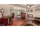 Living room with wood-look flooring, ceiling fans, and comfortable seating at 10330 W Desert Forest Cir, Sun City, AZ 85351