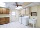 Laundry room with washer, dryer, cabinets, and utility sink at 12422 W Ginger Dr, Sun City West, AZ 85375