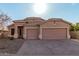 Tan two-story house with a two-car garage and desert landscaping at 13137 W Stella Ln, Litchfield Park, AZ 85340