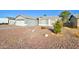 Exterior view of a single-story house with a two-car garage, gravel landscaping, and some plants at 1366 E Autumn Sage Trl, Casa Grande, AZ 85122