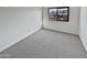 Empty bedroom with gray carpet and large window at 1433 N 53Rd Ave, Phoenix, AZ 85043