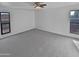 Spacious bedroom with gray carpet, ceiling fan, and multiple windows at 1433 N 53Rd Ave, Phoenix, AZ 85043