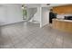 Open living area with tiled floor and view of the kitchen and staircase at 1433 N 53Rd Ave, Phoenix, AZ 85043