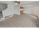 Living room with tile flooring, a ceiling fan, and stairs leading to the second floor at 1433 N 53Rd Ave, Phoenix, AZ 85043