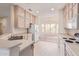 Bright kitchen features ample cabinetry, an island, and a view to the dining area at 15451 W Gunsight Dr, Sun City West, AZ 85375