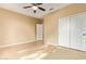 Bedroom with tile flooring, double doors to closet, and ceiling fan at 16846 W Almeria Rd, Goodyear, AZ 85395