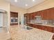 Kitchen island with granite countertop, stainless steel sink, and view of the kitchen at 16846 W Almeria Rd, Goodyear, AZ 85395