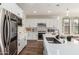 Modern kitchen with white cabinets, stainless steel appliances, and a large island at 17733 E Bear Wallow Way, Rio Verde, AZ 85263