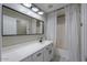 Clean bathroom with white vanity, bathtub, and patterned flooring at 19776 N Harris N Dr, Maricopa, AZ 85138