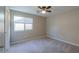 Bright bedroom featuring carpeted floors and ceiling fan at 19776 N Harris N Dr, Maricopa, AZ 85138