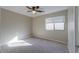 Well-lit bedroom with carpet and ceiling fan at 19776 N Harris N Dr, Maricopa, AZ 85138