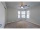 Bedroom with bay window, carpet, and ceiling fan at 19776 N Harris N Dr, Maricopa, AZ 85138