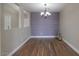 Dining area with hardwood floors and an accent wall at 19776 N Harris N Dr, Maricopa, AZ 85138