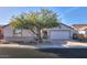Single-story home with a two-car garage and landscaped front yard at 19776 N Harris N Dr, Maricopa, AZ 85138