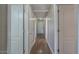 A long hallway with light walls and hardwood floors at 19776 N Harris N Dr, Maricopa, AZ 85138
